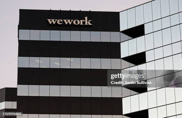 Sign is posted on the exterior of a WeWork office on November 01, 2023 in San Mateo, California. Shares of WeWork dropped over 35 percent in...