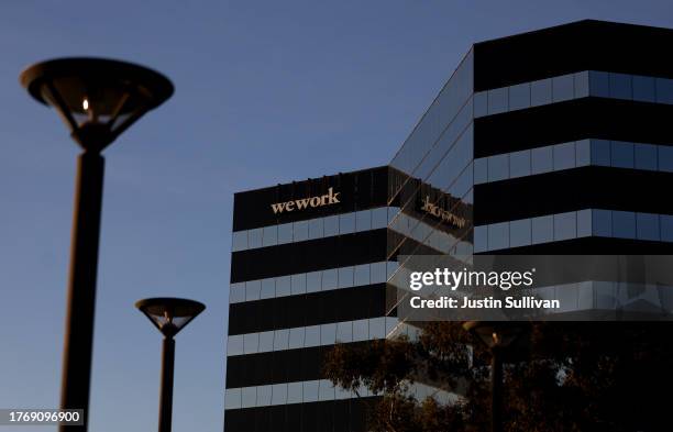 Sign is posted on the exterior of a WeWork office on November 01, 2023 in San Mateo, California. Shares of WeWork dropped over 35 percent in...