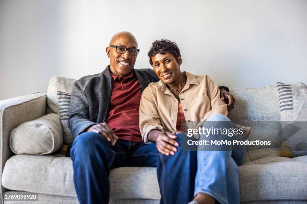 potrait of senior couple at home - cream coloured jacket stock pictures, royalty-free photos & images