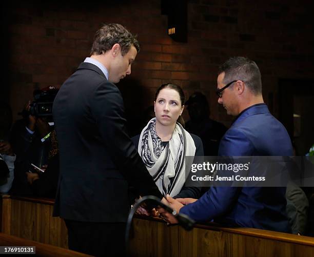 South African athlete Oscar Pistorius prays with his sister Aimee Pistorius and brother Carl Pistorius prior to his indictment hearing in Pretoria...