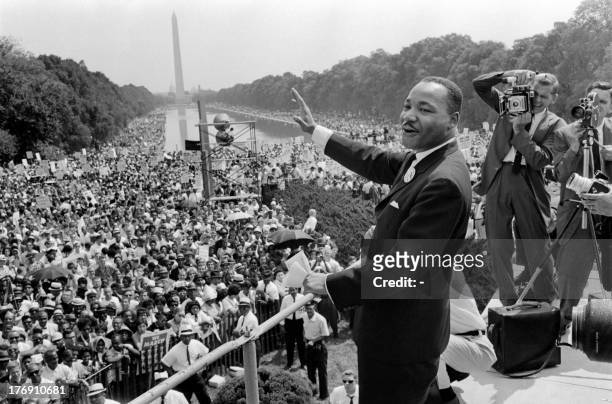 Civil rights leader Martin Luther King waves to supporters 28 August 1963 on the Mall in Washington DC during the "March on Washington", where King...