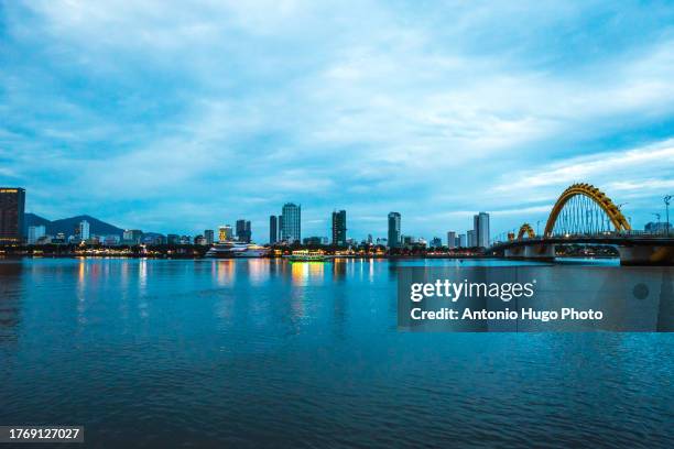 panoramic view of da nang city and dragon bridge at sunset. - river han stock pictures, royalty-free photos & images