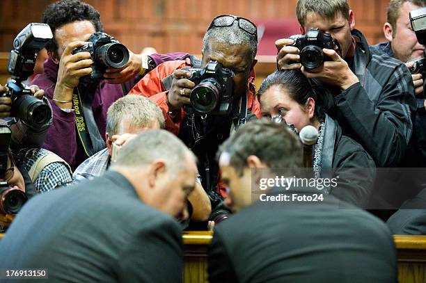 Media clamber to get a picture of Oscar Pistorius as he appears in the Pretoria Magistrates court on August 19 in Pretoria, South Africa. Pistorius...