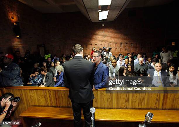 South African athlete Oscar Pistorius and his brother Carl Pistorius appear in Pretoria Magistrates Court for an indictment hearing on August 19,...