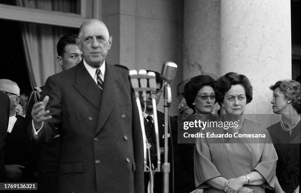 French President Charles de Gaulle gives a speech at the French Embassy during a State Visit, Buenos Aires, Argentina, 1964. Among those behind him...