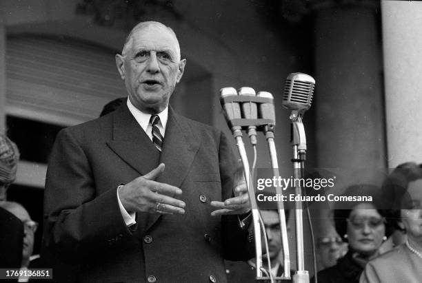 French President Charles de Gaulle gives a speech at the French Embassy during a State Visit, Buenos Aires, Argentina, 1964. Among those behind him...