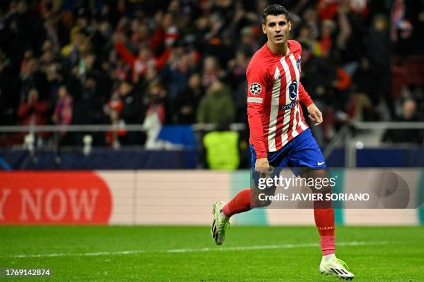 Atletico Madrid's Spanish forward Alvaro Morata celebrates scoring his team's fifth goal during the UEFA Champions League group E football match...