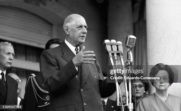 French President Charles de Gaulle gives a speech at the French Embassy during a State Visit, Buenos Aires, Argentina, 1964. Among those behind him...