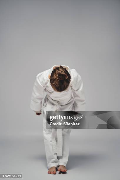 karate girl bowing and saluting - child saluting stock pictures, royalty-free photos & images