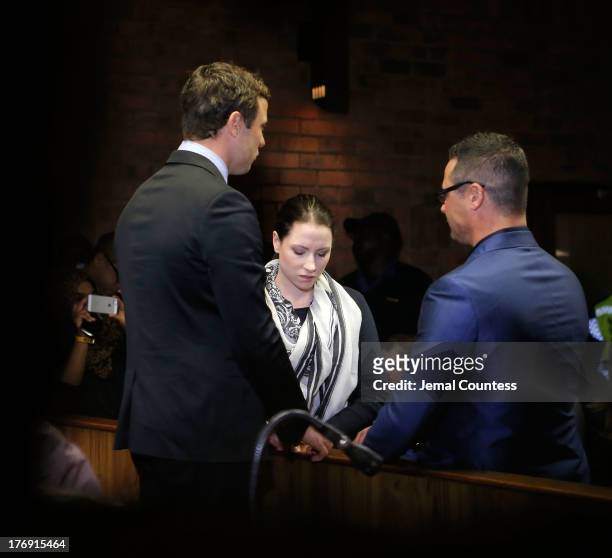 South African athlete Oscar Pistorius prays with his sister Aimee Pistorius and brother Carl Pistorius prior to his indictment hearing in Pretoria...