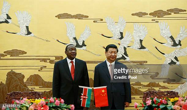 Kenyan President Uhuru Kenyatta and his Chinese President Xi Jinping stand during a signing ceremony for a visa exemption agreement in the Great Hall...