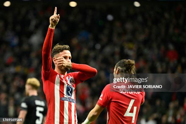 Atletico Madrid's Spanish midfielder Saul Niguez celebrates scoring his team's sixth goal during the UEFA Champions League group E football match...