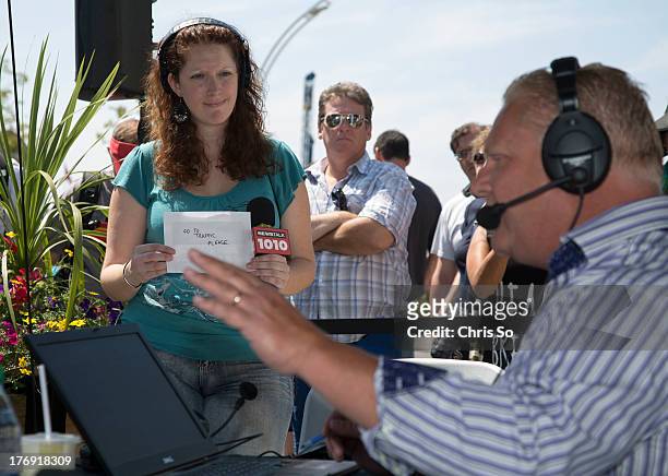 Toronto, ON - AUGUST 18 - Newstalk The City producer Becky Coles tries to signal Doug Ford to break for traffic announcement. The Ford brothers had...