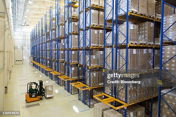 An employee drives a pallet of pharmaceuticals into a storage bay using a forklift truck at OAO Pharmstandard's Leksredstva drug manufacturing unit...