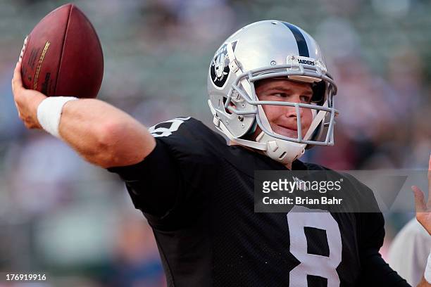 Quarterback Tyler Wilson of the Oakland Raiders warms up before a preseason game against the Dallas Cowboys on August 9, 2013 at O.co Coliseum in...