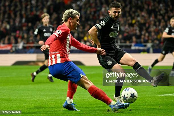 Atletico Madrid's French forward Antoine Griezmann is challenged by Celtic's American defender Cameron Carter-Vickers during the UEFA Champions...