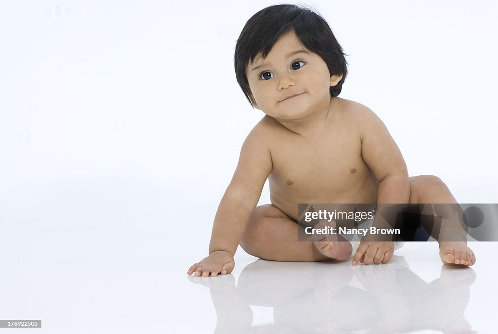 Baby sitting on white
