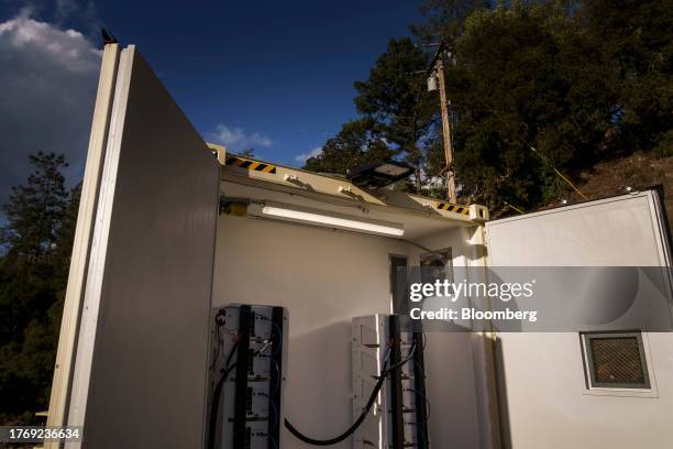 De-energized power distribution line, top, above a BoxPower SolarContainer housing lithium-ion batteries, part of a PG&E Corp. Remote grid power...