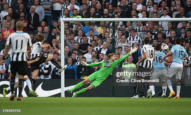 David Silva of Manchester City scores the first goal past Tim Krul of Newcastle United during the Barclays Premier League match between Manchester...