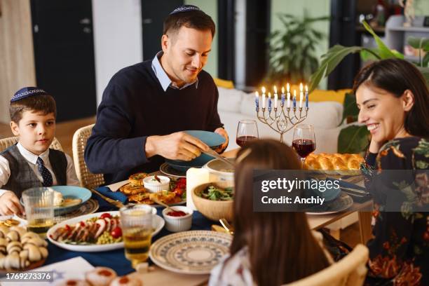 traditional jewish family eating matzo ball soup - sufganiyah stock pictures, royalty-free photos & images