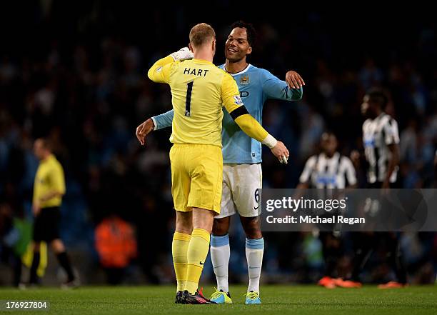 Manchester City teammates Joe Hart and Joleon Lescott celebrate their team's 4-0 victory during the Barclays Premier League match between Manchester...