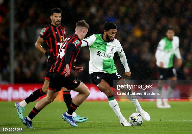 Joe Gomez of Liverpool on the ball whilst under pressure from Alex Scott of AFC Bournemouth during the Carabao Cup Fourth Round match between AFC...