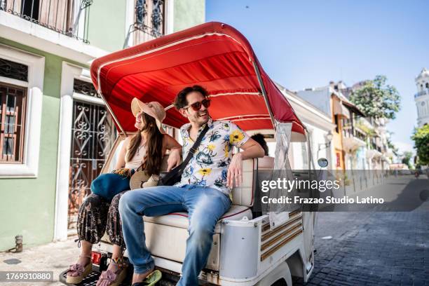 tourist couple in rickshaw ride in historic district - dominican republic stock pictures, royalty-free photos & images