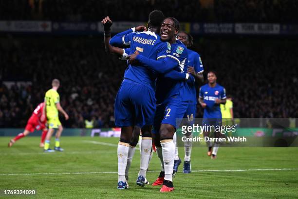 Benoit Badiashile of Chelsea celebrates with teammate Axel Disasi after scoring the team's first goal during the Carabao Cup Fourth Round match...
