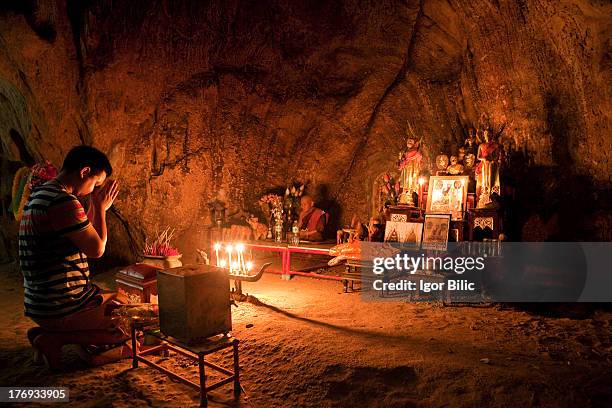 Buddhist devotee praying in Tham Phraya Nakhon cave. It is located in Sam Roi Yot National Park in Prachuap Khiri Khan province. It is probably the...