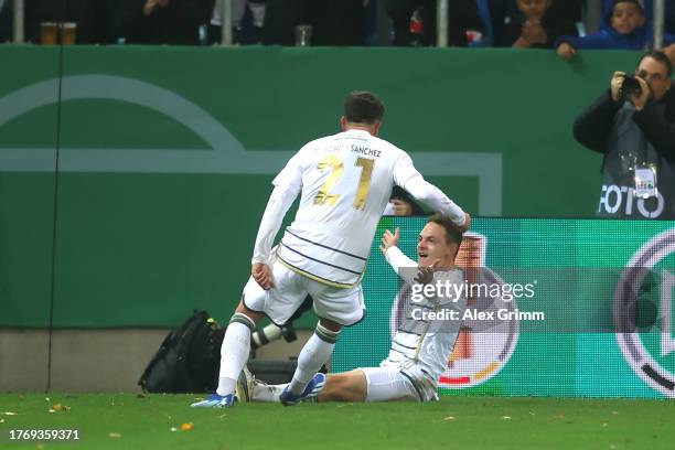 Patrick Sontheimer of FC Saarbrücken celebrates with teammate Fabio Di Michele Sanchez after scoring the team's first goal during the DFB cup second...