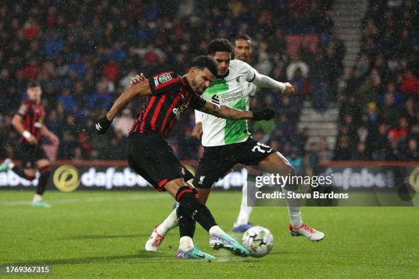 Dominic Solanke of AFC Bournemouth takes a shot whilst under pressure from Jarell Quansah of Liverpool during the Carabao Cup Fourth Round match...