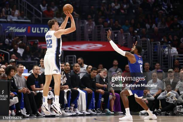 Franz Wagner of the Orlando Magic attempts a three-point basket against Paul George of the Los Angeles Clippers during the first quarter at...