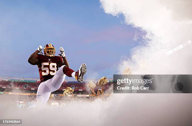 Linebacker London Fletcher of the Washington Redskins is introduced before the start of a preseason game against the Pittsburgh Steelers at...