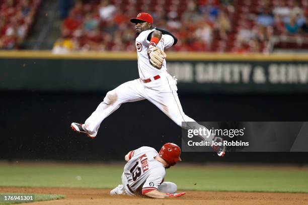 Brandon Phillips of the Cincinnati Reds turns a double play in the ninth inning against Jason Kubel of the Arizona Diamondbacks during the game at...