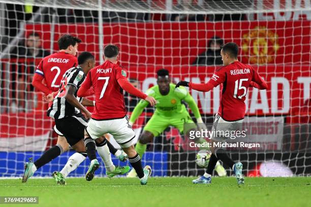 Joe Willock of Newcastle United scores their sides third goal during the Carabao Cup Fourth Round match between Manchester United and Newcastle...