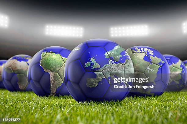 world soccer balls on pitch - internationaler fußball stock-fotos und bilder