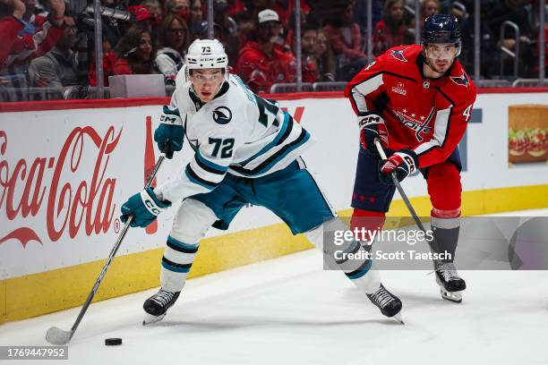 William Eklund of the San Jose Sharks skates with the puck in front of Hardy Haman Aktell of the Washington Capitals during the first period of the...