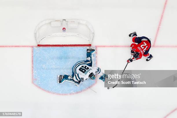 Evgeny Kuznetsov of the Washington Capitals attempts to score against Mackenzie Blackwood of the San Jose Sharks during the first period of the game...