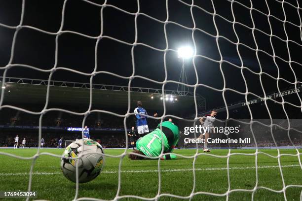 Tom Cairney of Fulham scores their sides third goal past Christian Walton of Ipswich Town during the Carabao Cup Fourth Round match between Ipswich...