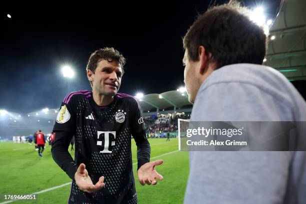 Thomas Mueller of Bayern Munich talks to a member of the crowd following the team's defeat during the DFB cup second round match between 1. FC...