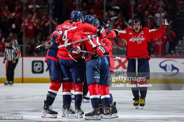 Dylan Strome of the Washington Capitals celebrates with Hardy Haman Aktell, Tom Wilson, and Alex Ovechkin after scoring a goal against the San Jose...