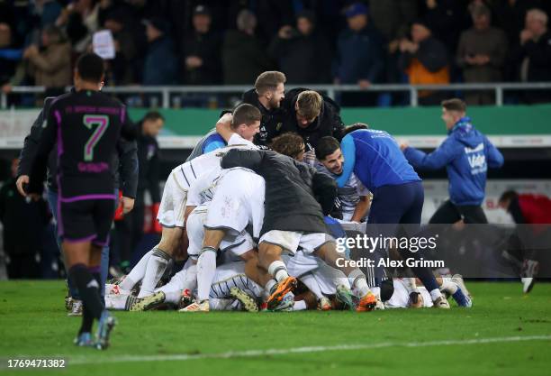 Saarbrücken players celebrate following the team's victory during the DFB cup second round match between 1. FC Saarbrücken and FC Bayern München at...