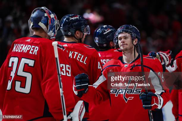 Darcy Kuemper of the Washington Capitals celebrates with Connor McMichael after the game against the San Jose Sharks at Capital One Arena on October...