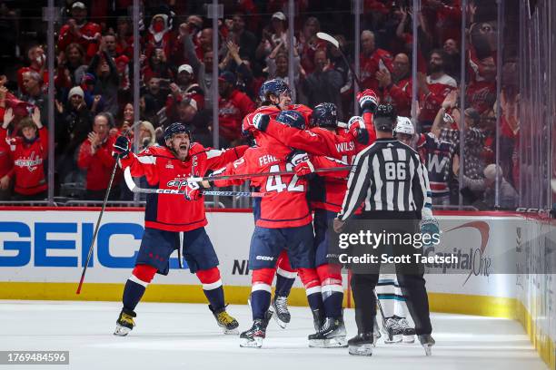 Tom Wilson of the Washington Capitals celebrates with Alex Ovechkin, Dylan Strome, Martin Fehervary after scoring a goal against the San Jose Sharks...