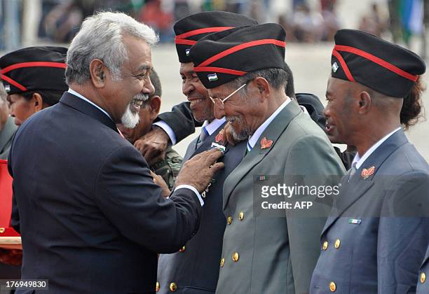 East Timorese Prime Minister Xanana Gusmao decorates former guerrillas during a ceremony to mark the 38th anniversary of the Falintil, the armed...