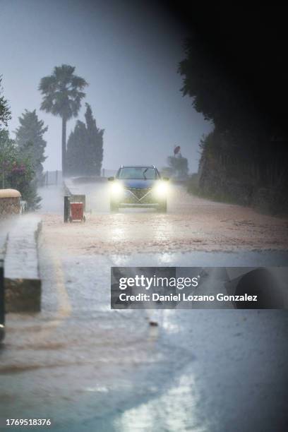 car with glowing headlights riding during storm - derecho stock pictures, royalty-free photos & images