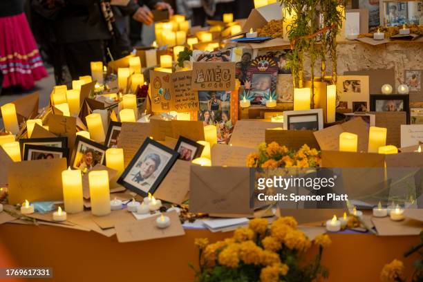 Candles, photos and flowers are displayed as people visit a chapel with remembrances of the deceased on the grounds of Greenwood Cemetery during a...