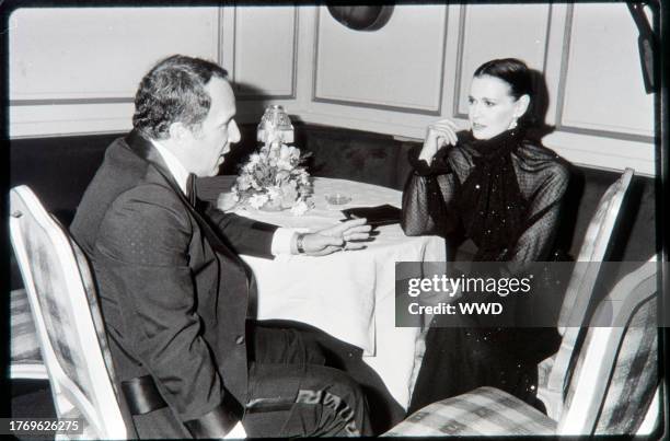 Designer Gloria Vanderbilt and guest attends a photo shoot event for the New York designer fall 1977 collections at Le Club in New York City.