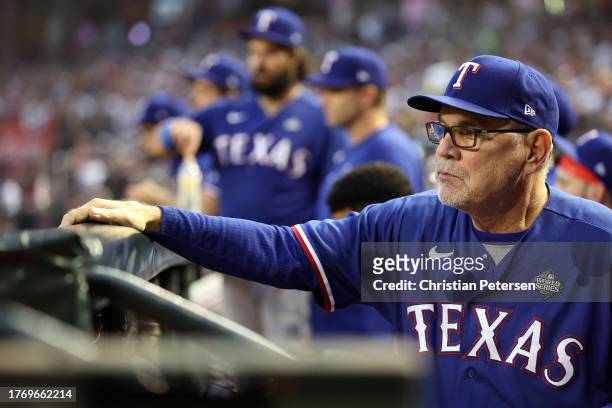 Manager Bruce Bochy of the Texas Rangers looks on from the dugout in the second inning against the Arizona Diamondbacks during Game Five of the World...