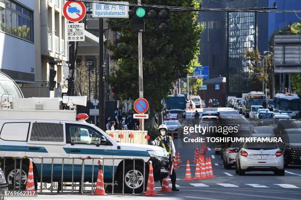 Police stand guard along the road connecting to Japan's Ministry of Foreign Affairs Iikura Guest House where the second day of the G7 Foreign...